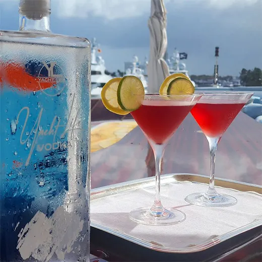 Pink cocktails on a yacht with the bottle beside them