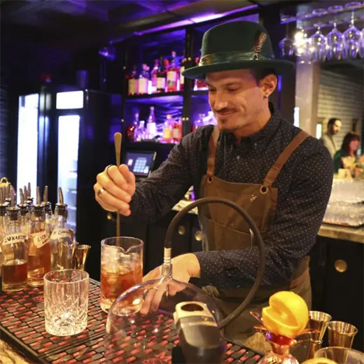 Bartender stirring a cocktail behind the bar